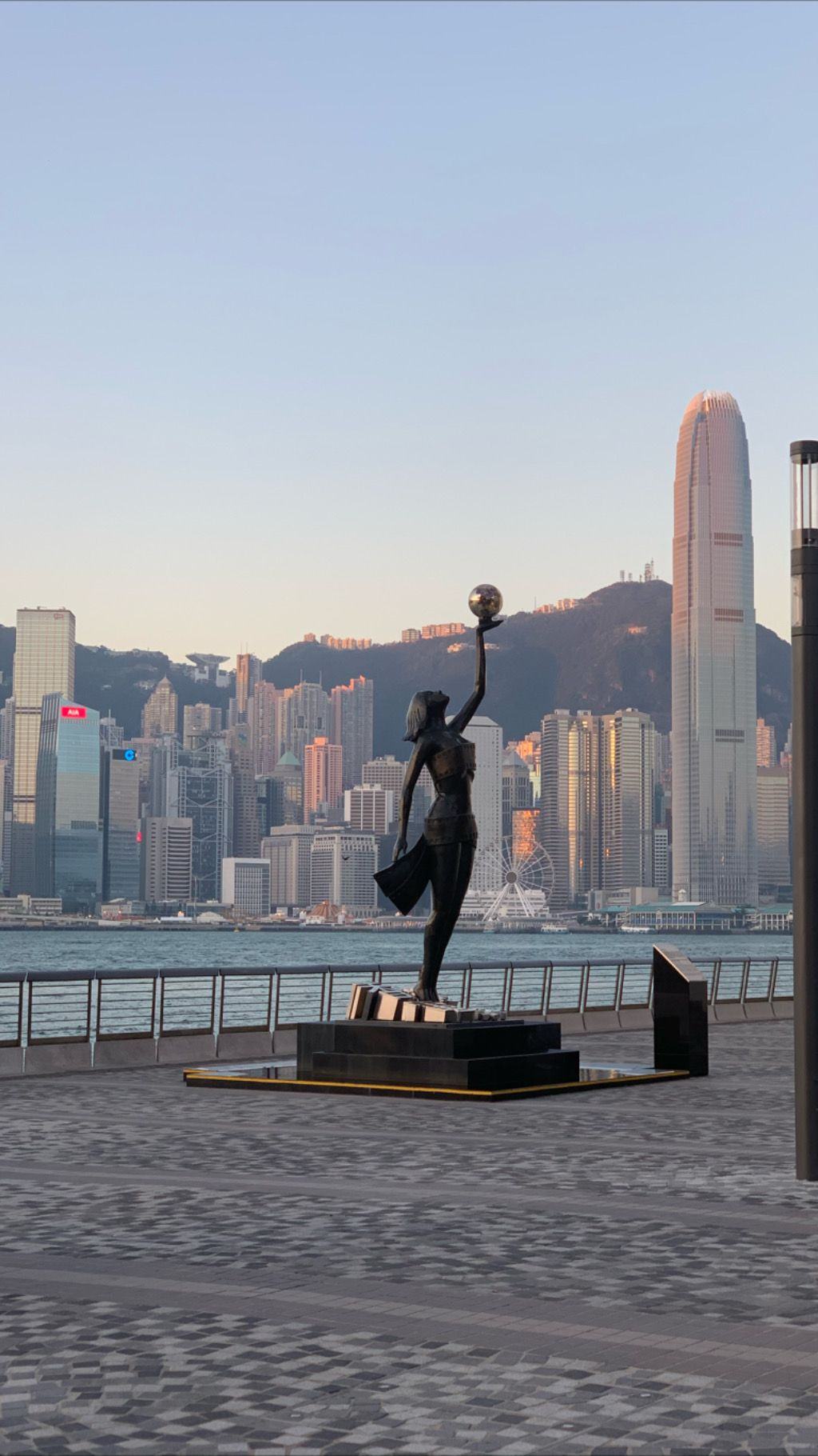 The Hong Kong skyline at dusk seen across Victoria Harbour.